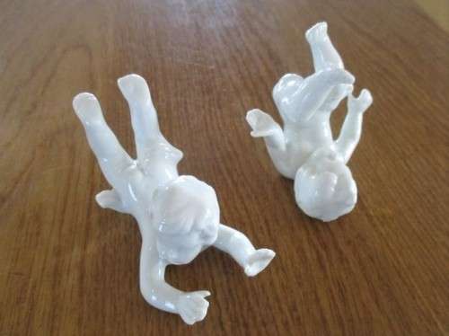 TWO VINTAGE PORCELAIN FROLICKING CHILDREN