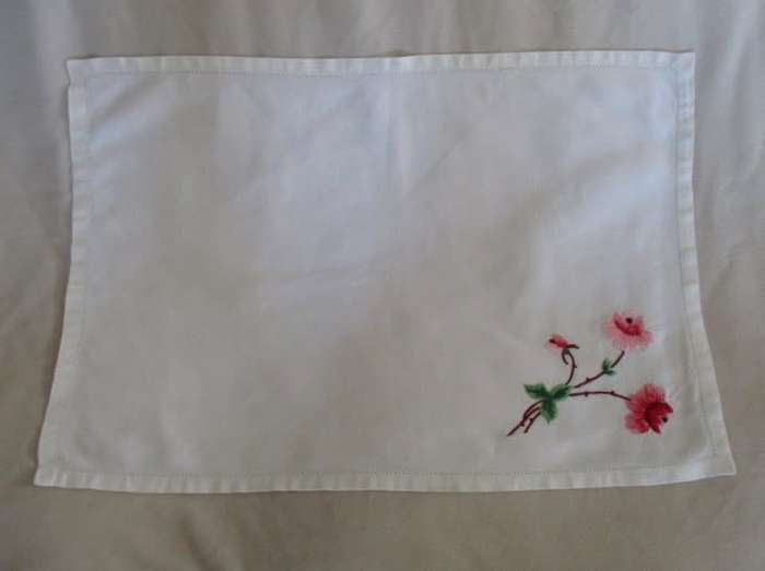 A VINTAGE RECTANGULAR VERY NEATLY HAND EMBROIDERED CLOTH WITH FLORAL DESIGN