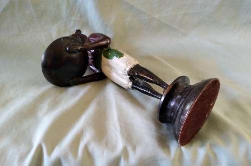 Decorative metal statuette of man holding a bowl
