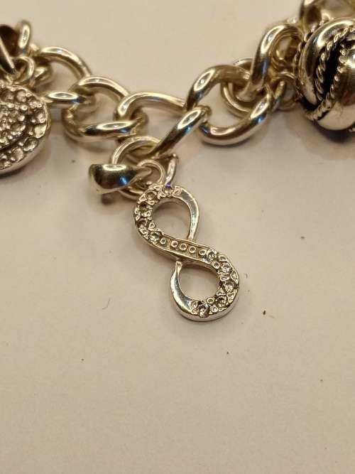 Sterling silver charm bracelet with 11 charms 21cm long