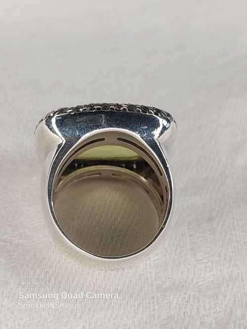 Sterling silver ladies ring with very large green stone surrounded with cubic zirconia Size: M.5