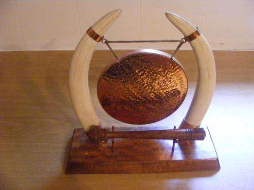 FABULOUS DINNER GONG SURROUNDED BY TUSKS