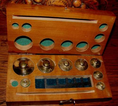 Set of 8 solid good quality antique brass weights in wooden box-not complete