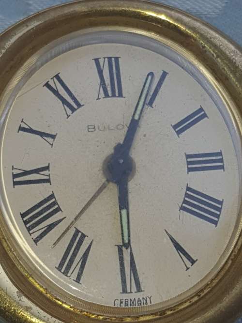 A COLLECTION OF FIGURINES JADE AND SILVER-PLATED BELL AND A BULOVA WATCH SOLD AS IS