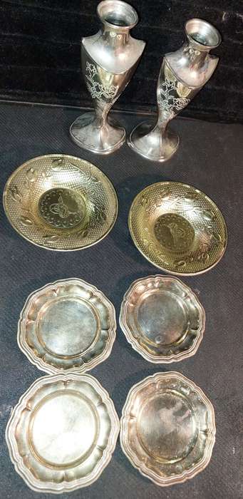 A collection of vintage utensils and a pair of silver-plated candle holders in good condition sold a