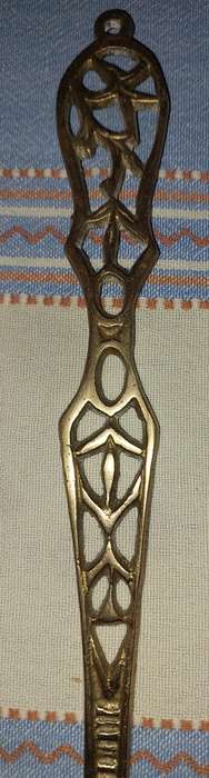 A SET OF ORNAMENTAL BRASS LADEL AND FORK MADE IN ISREAL LENGTH 35 TO 40 CENTIMETERS SOLD AS IS