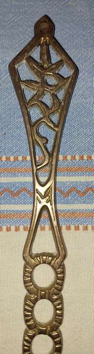 A SET OF ORNAMENTAL BRASS LADEL AND FORK MADE IN ISREAL LENGTH 35 TO 40 CENTIMETERS SOLD AS IS