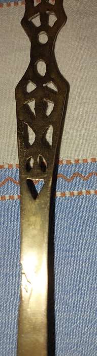 A SET OF ORNAMENTAL BRASS LADEL AND FORK MADE IN ISREAL LENGTH 35 TO 40 CENTIMETERS SOLD AS IS