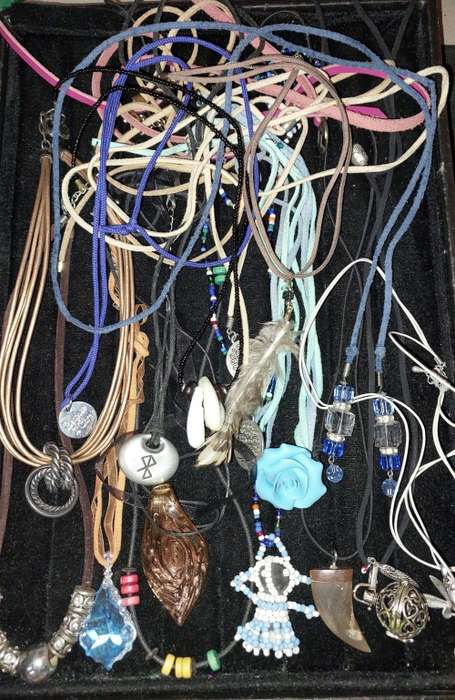 A BULK COLLECTION OF LEATHER ROPE COSTUME NECKLACES SOLD AS IS