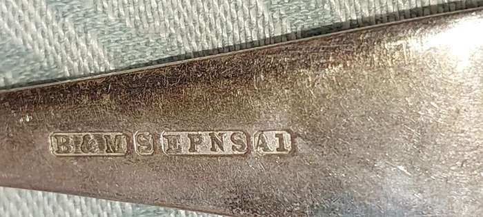 AN ANTIQUE SET OF TABLE FORKS SOLD AS IS