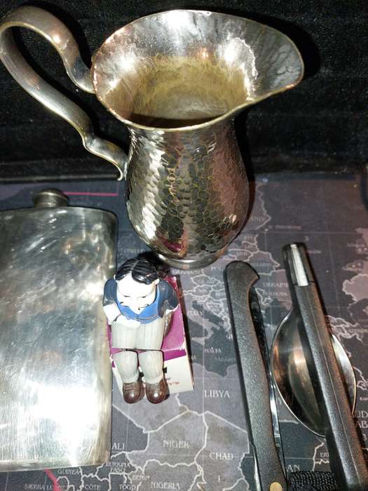 A COLLECTION OF FLASKS CIGARETTE LIGHTERS  POCKET KNIVES AND A LEATHER CIGARETTE HOLDER SOLD AS IS