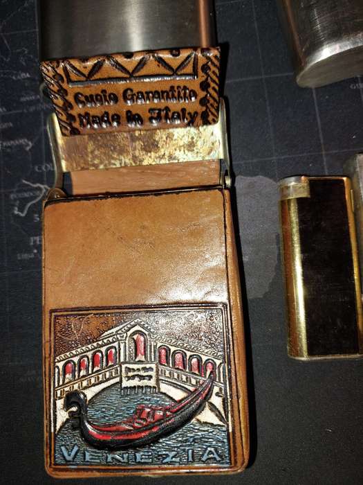 A COLLECTION OF FLASKS CIGARETTE LIGHTERS  POCKET KNIVES AND A LEATHER CIGARETTE HOLDER SOLD AS IS