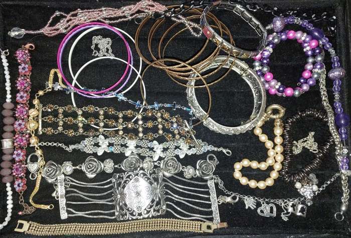 A BULK VINTAGE COLLECTION OF BRACELETS AND BANGLES SOLD AS IS