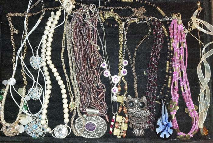 A BULK COLLECTION OF COSTUME JEWELRY AND THE PLASTIC CASES SOLD AS IS