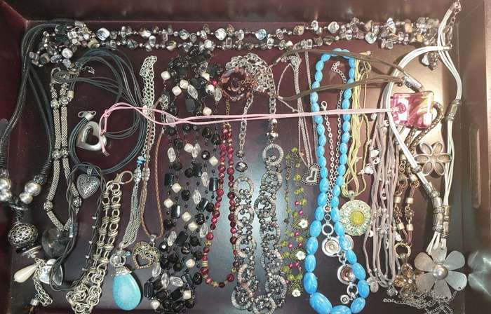 A BULK COLLECTION OF COSTUME JEWELRY AND THE PLASTIC CASES SOLD AS IS