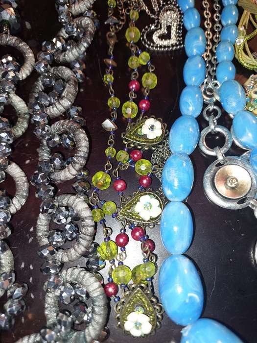 A BULK COLLECTION OF COSTUME JEWELRY AND THE PLASTIC CASES SOLD AS IS
