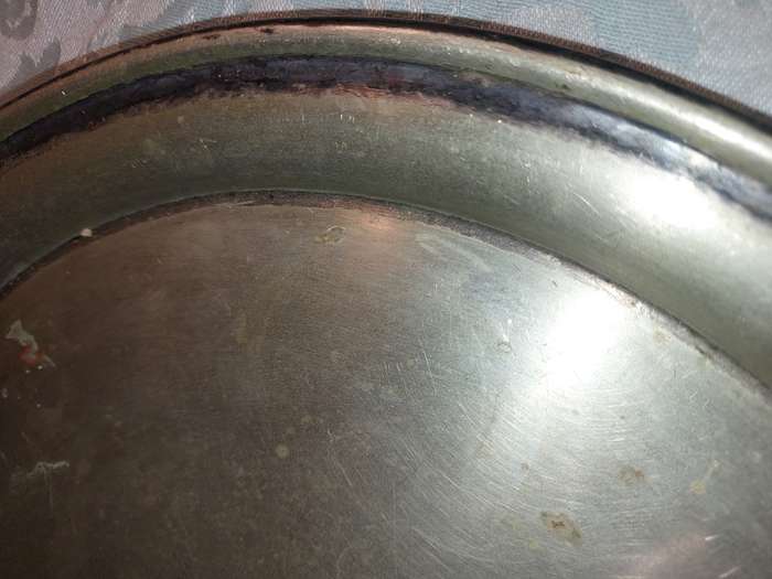 A ROUND CATERERS TRAY SILVER PLATED NEEDS TO BE POLISHED AND SOLD AS IS