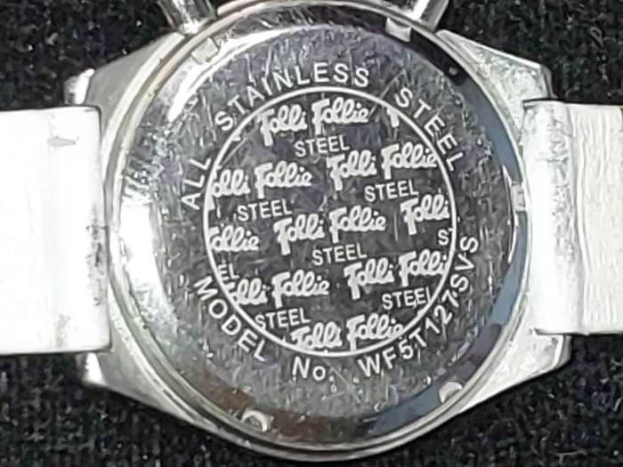 A FOLLI FOLLIE WITH WHITE ENEMAL BAZEL D/D AND WHITE LEATHER BAND