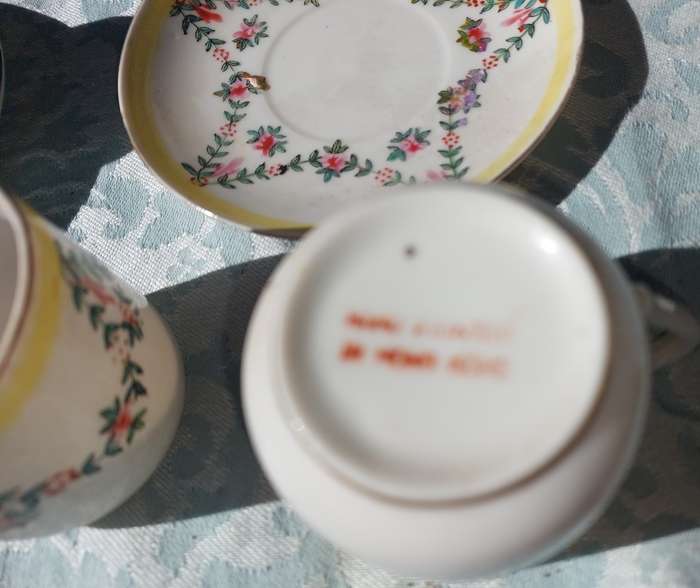 A COLLECTION OF HAND PAINTED TEA CUPS AND SAUCERS