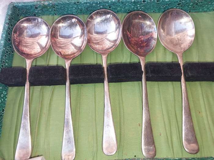 AN ANTIQUE SET OF SPOONS SOLD AS IS