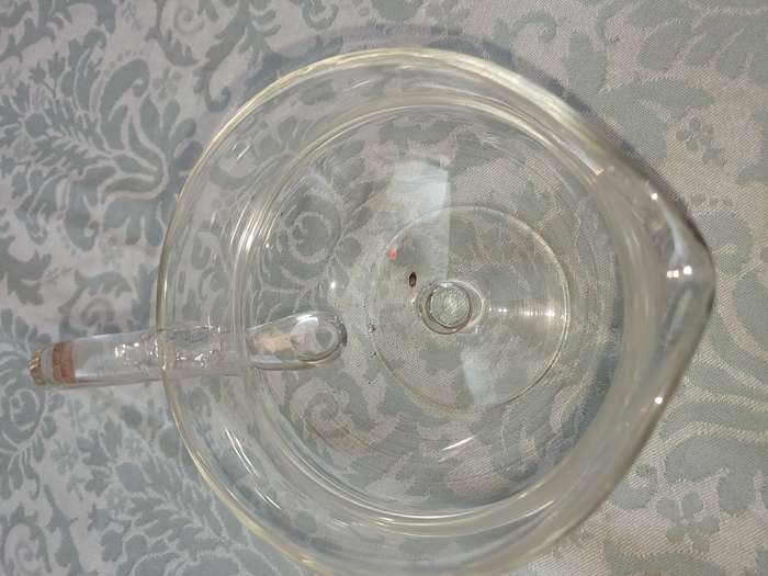A GLASS SOUCE JUG SOLD AS IS