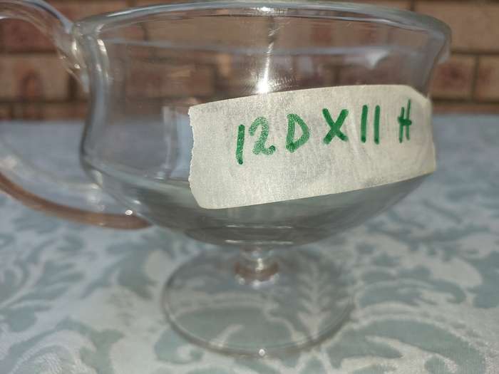 A GLASS SOUCE JUG SOLD AS IS