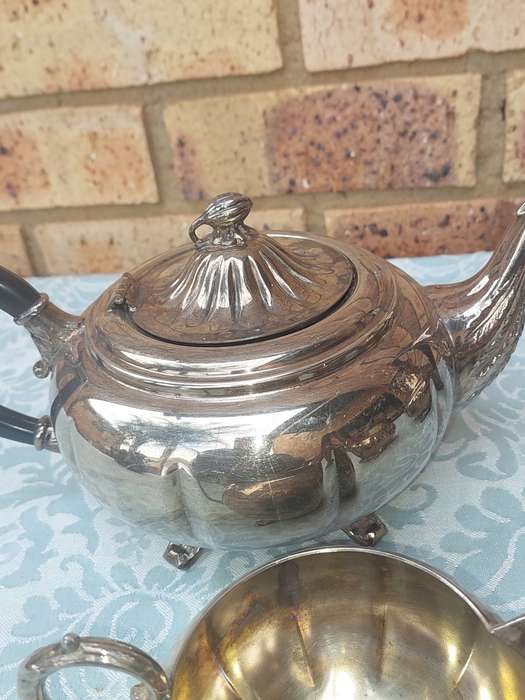 AN ANTIQUE TEA JUG SET SOLD AS IS