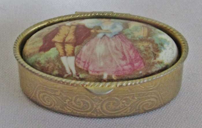 Vintage gold tone Rococo style pill box with Fragonard Courting Couple Decoration
