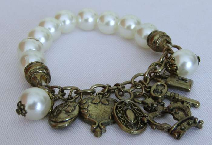 Vintage faux pearl stretch bracelet with brass tone charms