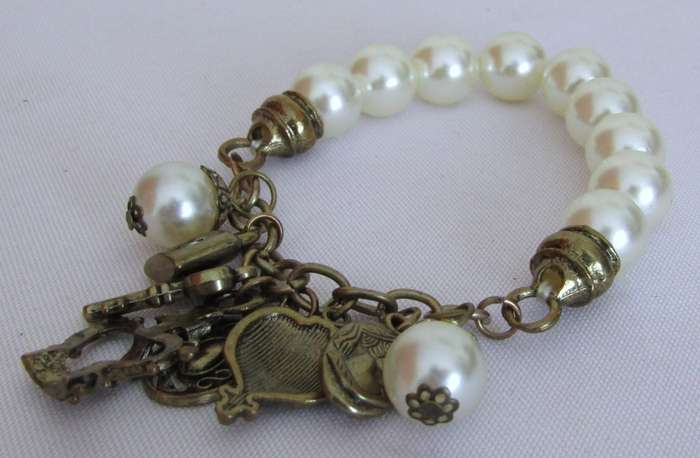 Vintage faux pearl stretch bracelet with brass tone charms