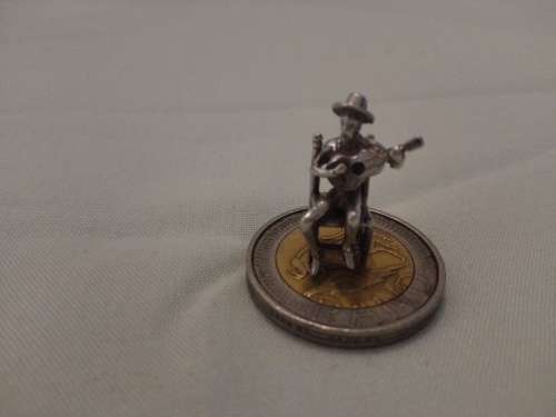 silver charm man with guitar