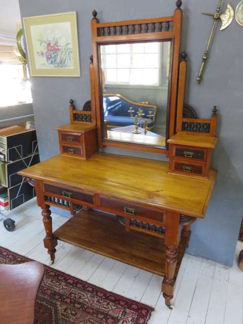 Early 20th century blonde mahogany two tier dressing table with a swing mirror.