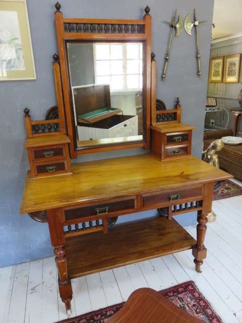 Early 20th century blonde mahogany two tier dressing table with a swing mirror.