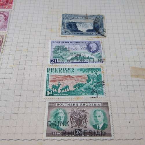 Old stamp album with over 300 stamps - some loose