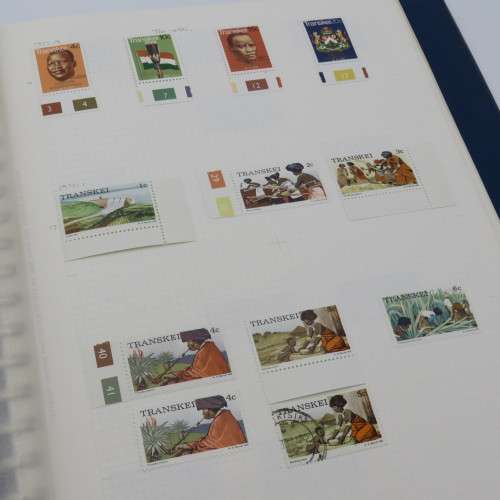 Album with over 1100 stamps including Transkei and Venda mint collections and a lot of USA stamps