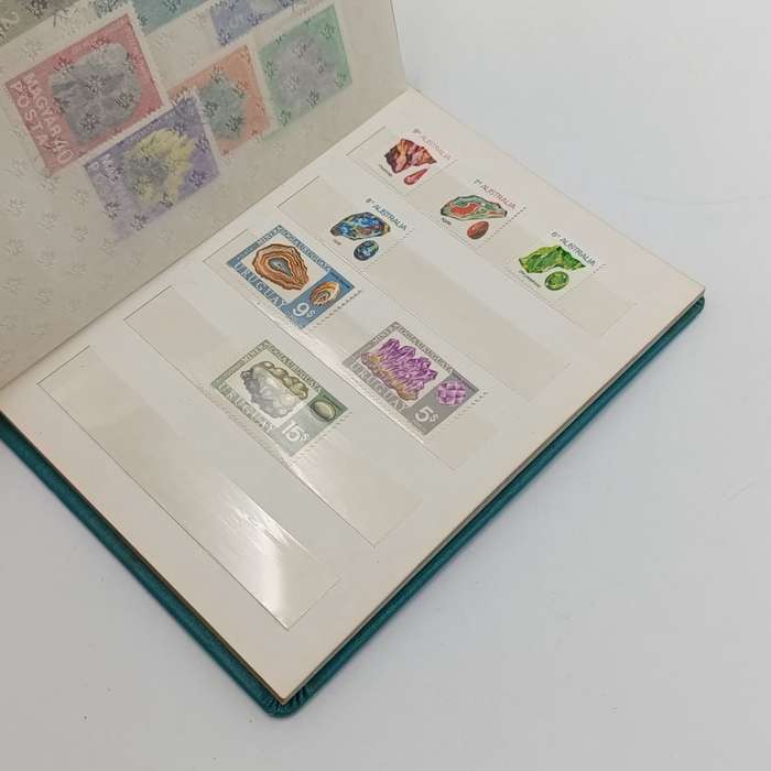 Lot of 92 mostly mint stamps with fossils & minerals - in 14 page small album