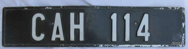 NUMBER PLATE : CAH 114 : 52X11.5cm : **NOTE SCRATCHES AROUND RIM AND DENTS**
