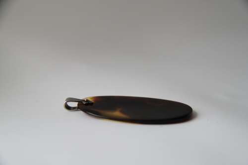 Tortoise shell pendant with sterling silver floral inlay