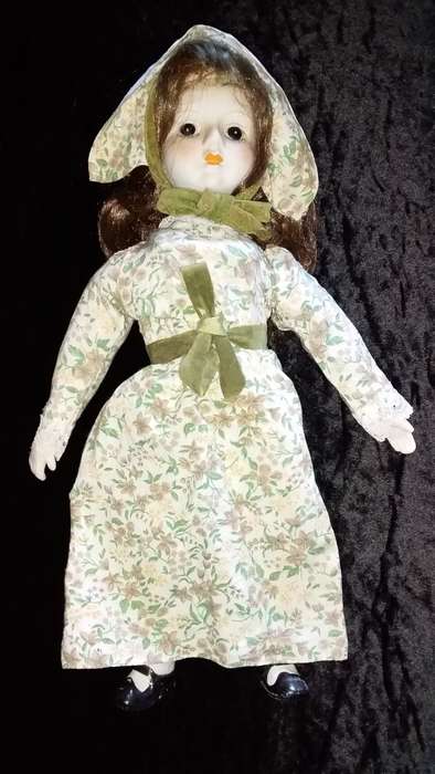 Collectors Doll-Not Marked. Orange flowers and green vines and leaves. Painted on shoes.