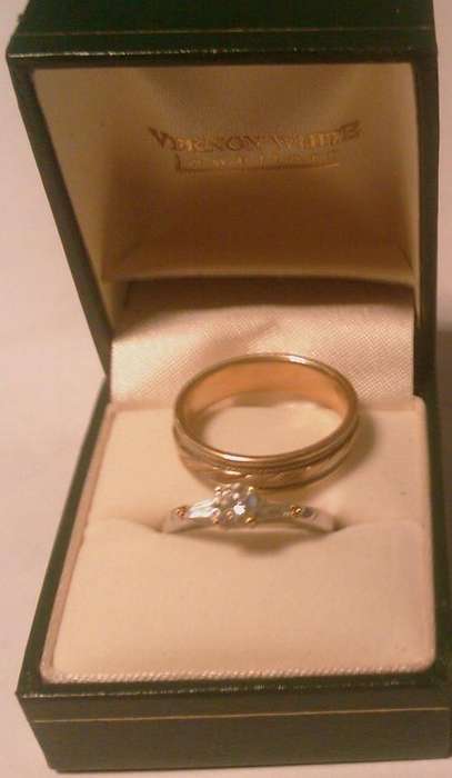 engagement ring and mens ring - indoor lighting