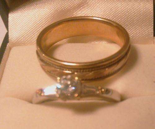 engagement ring and mens ring - close-up - indoor lighting