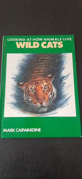 Looking at how animals live WILD CATS by Mark Carwardine