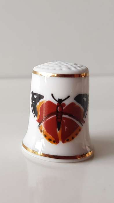 A Vintage collectors thimble. Thimble has two painted butterflies