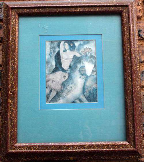 A framed litho of Lady Godiva and lover