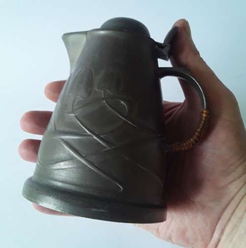 Antique Arts and Crafts pewter jug in the style of Liberty and Co. Hand-beaten lily pattern.