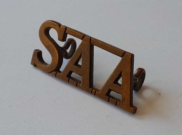 South Africa Army Artillery Brass Title. Lugs Intact.