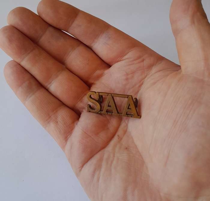 South Africa Army Artillery Brass Title. Lugs Intact.
