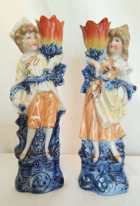 Vintage porcelain couple carrying vases