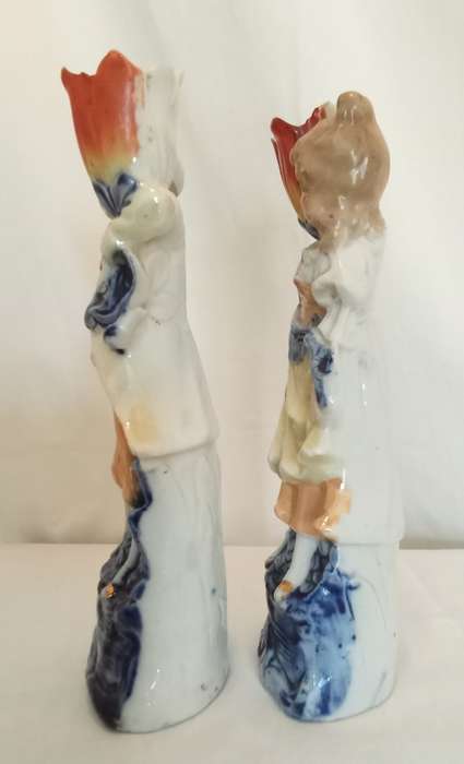 Vintage porcelain couple carrying vases