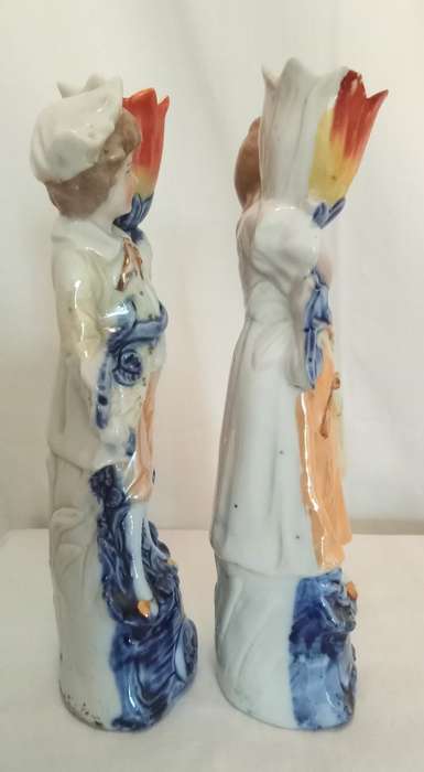Vintage porcelain couple carrying vases